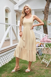 Detail of beige sleeveless midi dress with elastic pleated waist and tiered ruffle hem