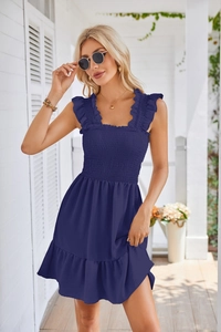 Detail of smocked sleeveless navy dress featuring ruffled straps and lightweight fabric