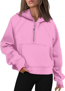Pink half-zip cropped hoodie with cozy thumbholes and spacious kangaroo pocket detail