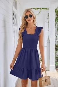 Detail of dark blue sleeveless smocked dress with ruffled square neck and elastic texture