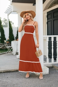 Close-up of brick red midi dress featuring white scalloped trim and textured woven fabric