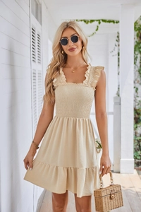 Detail of smocked sleeveless dress bodice with elegant square neck and ruffled straps