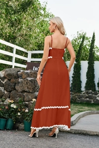 Close-up of orange midi dress featuring white ric-rac trim and smocked back detail