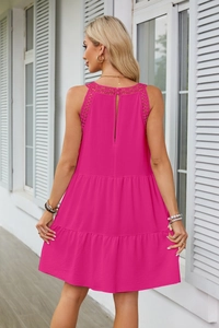 Dettaglio dell'abito allacciato al collo fucsia con pizzo all'uncinetto e spacco sul retro