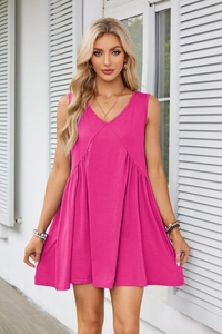 Detail of V-neck sleeveless magenta dress with pleated waist and side pockets