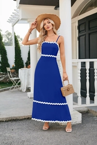 Detailed close-up of dark blue midi dress featuring white scalloped trim and ruched details