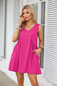 Detail of rose red V-neck sleeveless dress featuring pleated waist and functional side pockets