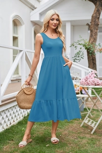 Detail of blue sleeveless midi dress featuring functional side pockets and ruffled hemline