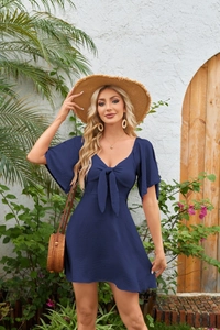 Detail of V-neck neckline with bow tie and flare sleeves on navy blue mini dress