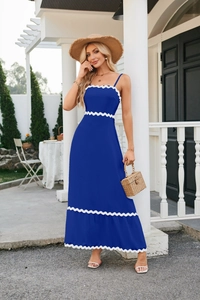 Detail of blue summer dress showing white scallop trim and textured fabric on the hemline