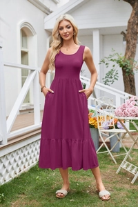 Detail of square neck sleeveless dress in plum purple with pleated hem and side pockets