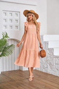 Side view of an apricot flutter sleeve dress with square neck and smocked bodice detail