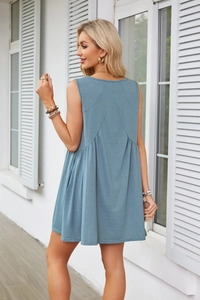 Detail view of the pleat stitching and side pocket on this blue sleeveless A-line dress