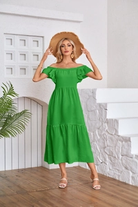 Detail of emerald green off-shoulder pleated dress with ruffled hem and summer texture
