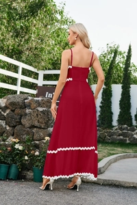 Detail of red sundress featuring white wavy lace trim and elastic smocked back design