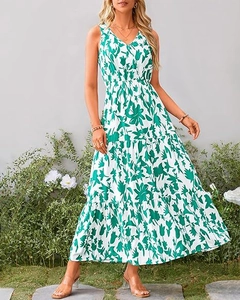 Detail of V-neck printed sleeveless maxi dress with tiered skirt in a garden setting
