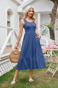 Detail view of the deep blue sleeveless dress showing side pockets and pleated waistline