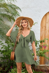 Detail of olive green V-neck dress with ruffle sleeves and stylish bow tie at the front