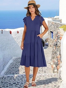 Detail of the navy blue tiered dress with V-neckline and ruffled sleeve accents