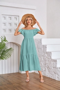 Detailed view of mint green off-shoulder dress with ruffled sleeves and tiered skirt