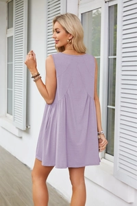 Detail view of the back pleats and V-shape stitching on the purple sleeveless dress