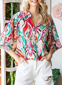 Close-up of bohemian paisley printed blouse with lantern sleeves and classic collar detail
