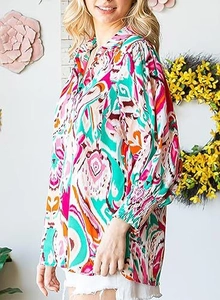 Detail of smocked cuffs and bohemian floral print on women's long sleeve blouse