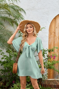 Detail of V-neck mint green mini dress with tie-up bow and ruffled bell sleeves
