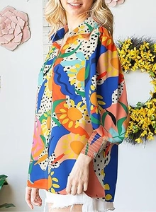 Detail of colorful pop art print blouse with lantern sleeves and vibrant abstract patterns