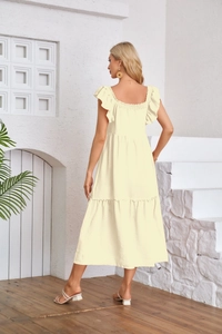 Detail of light yellow tiered midi dress with ruffle sleeves and pleated texture