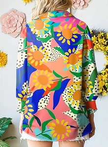 Close-up of the back view of a long-sleeved floral shirt featuring vibrant sunflower prints