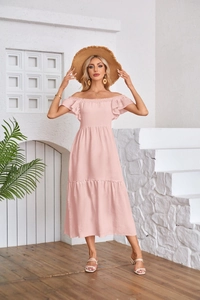 Detail of light pink off-shoulder dress with ruffled sleeves and tiered pleats