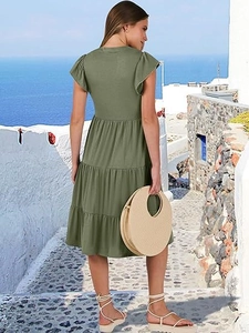 Outdoor shot of olive green tiered midi dress with ruffle sleeves and tiered skirt detail