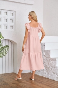 Detail view of light pink ruffled midi dress featuring flutter sleeves and layered hemline