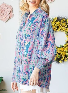 Detail of colorful watercolor floral print on shirt with smocked long lantern sleeves