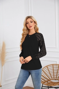 Detail of elegant lace patchwork sleeves and pleated neckline on a black women top