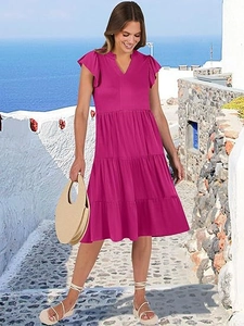 Detail of V-neck tiered midi dress with ruffle sleeves in vibrant hot pink summer fabric