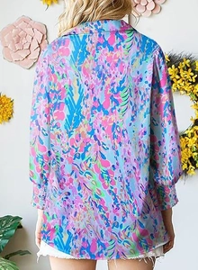 Back view of women's long sleeve floral shirt featuring abstract prints and lantern sleeves