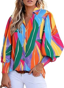 Detail view of colorful leaf print on a v-neck shirt with smocked lantern sleeve cuffs