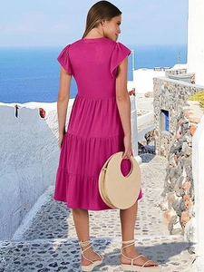 Detail of rose red midi dress featuring tiered ruffle skirt and elegant flutter sleeves