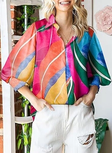 Detail of colorful abstract print shirt with classic collar and lantern sleeves on model