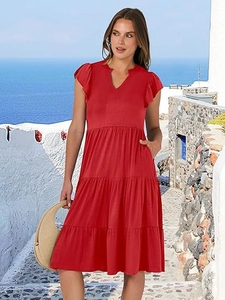 Macro detail of red V-neck ruffle sleeve dress with tiered skirt and practical side pockets