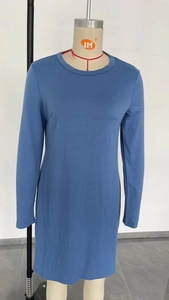Detail view of sky blue long sleeve dress with split hem and soft cotton fabric texture