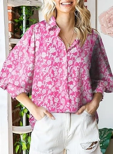 Detailed view of pink floral print shirt featuring a classic collar and button closure