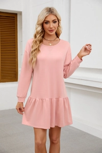 Detail of pink long-sleeve casual dress showing crew neck and ruffled hemline accents