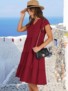 Close-up detail of burgundy V-neck tiered dress with flutter sleeves for a summer vacation look