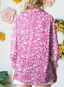 Macro detail of the rose pink floral print fabric and lantern sleeve cuff design