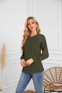 Detail of dark green top with elegant lace patchwork sleeves and pleated round neck