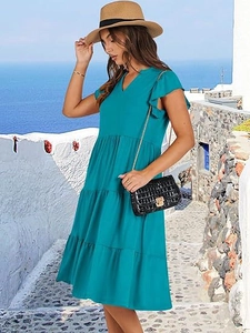 Detail of tiered bohemian midi dress with V-neck and ruffle sleeves in teal blue