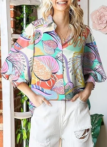 Detail of colorful tropical leaf print on long-sleeved shirt with elasticated cuffs